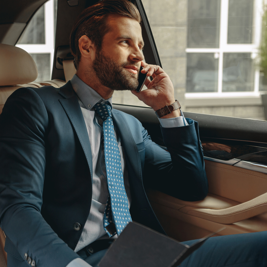 Professional making a phone call while traveling in a vehicle.