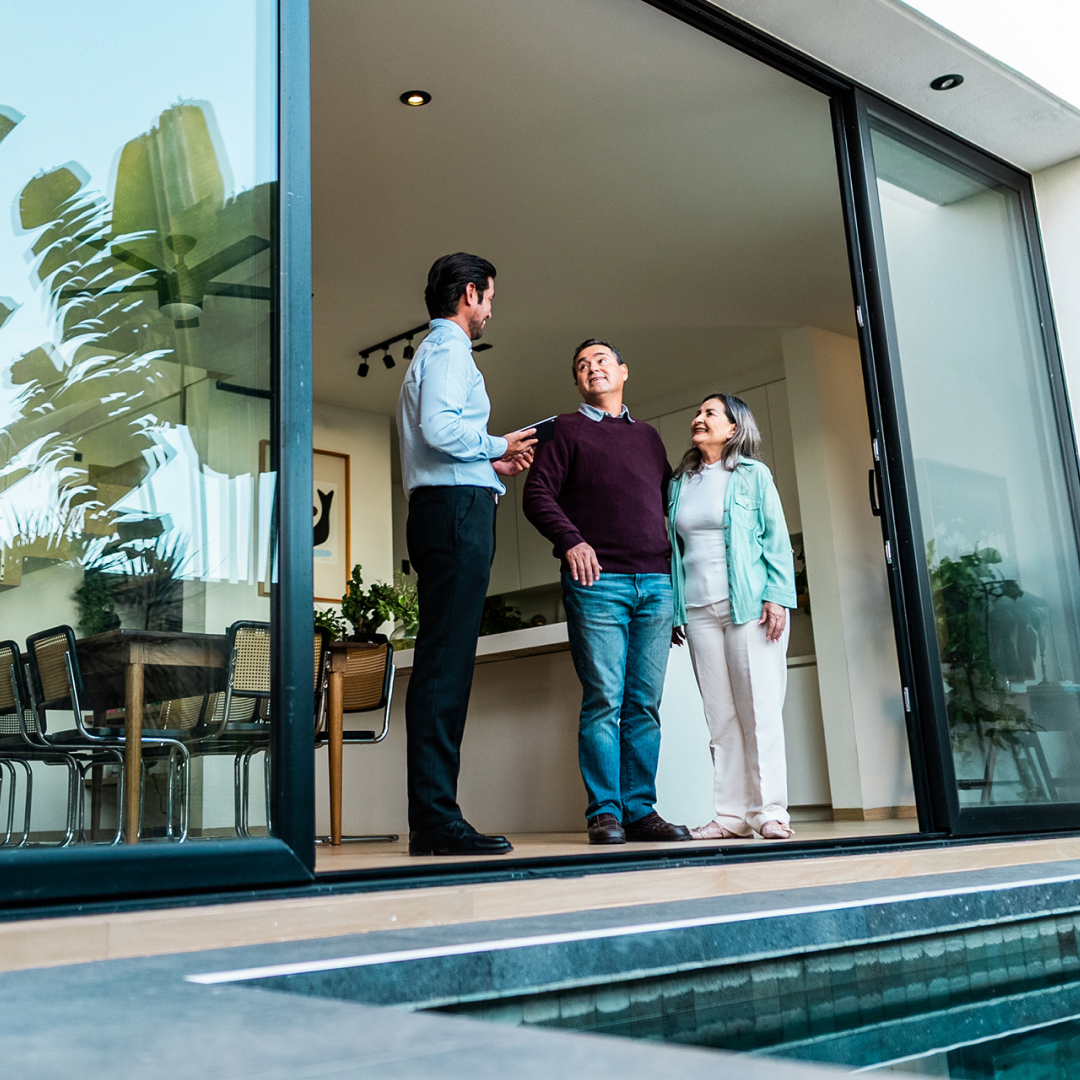 Homebuyers meeting with a real estate professional inside a modern home.
